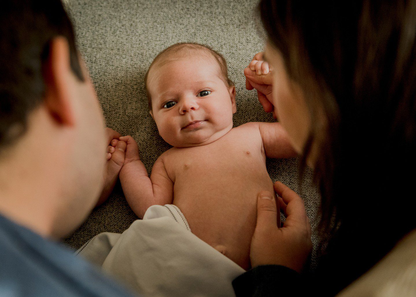 Mom and dad looking down at baby