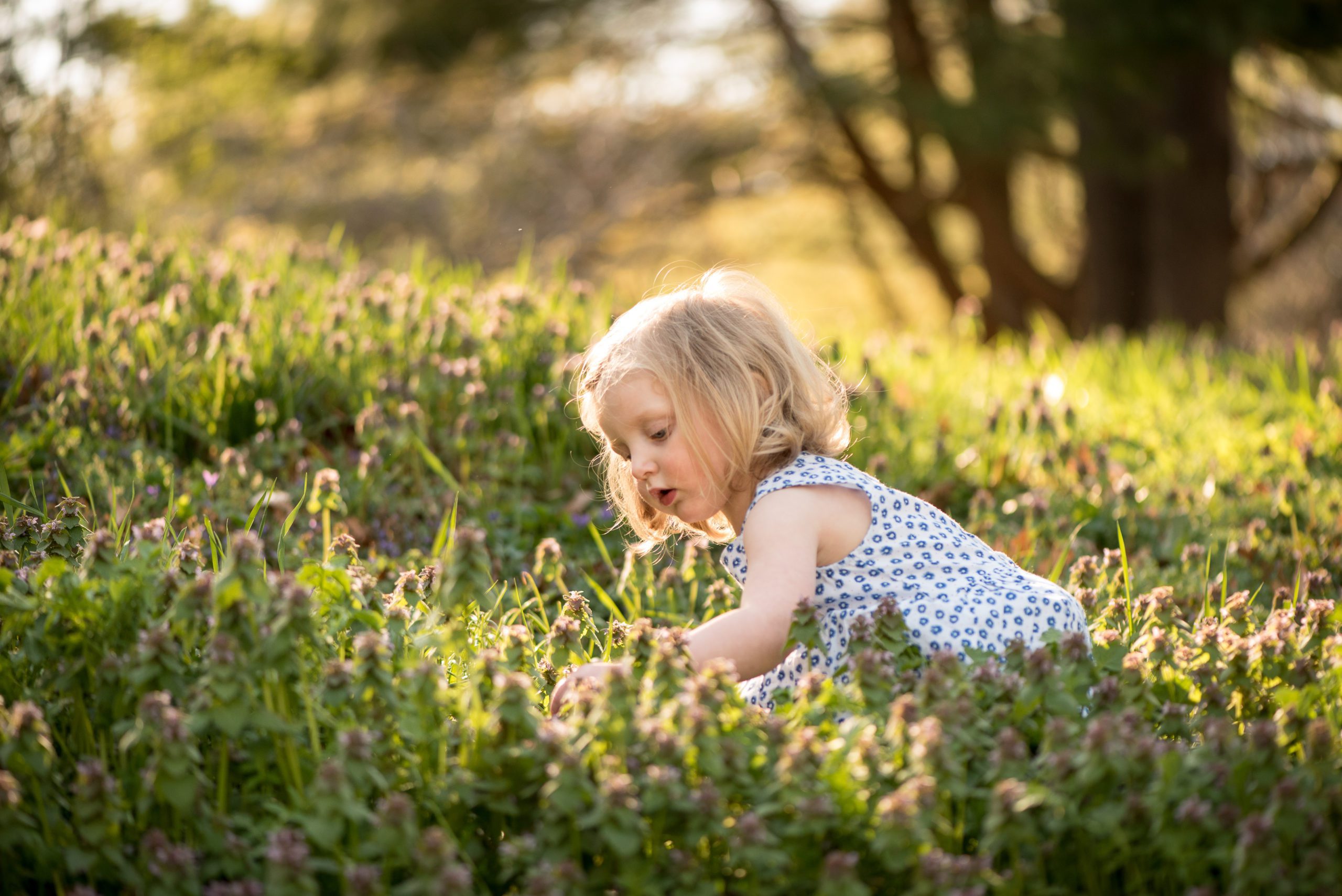 Girl surrounded by spring flowers 