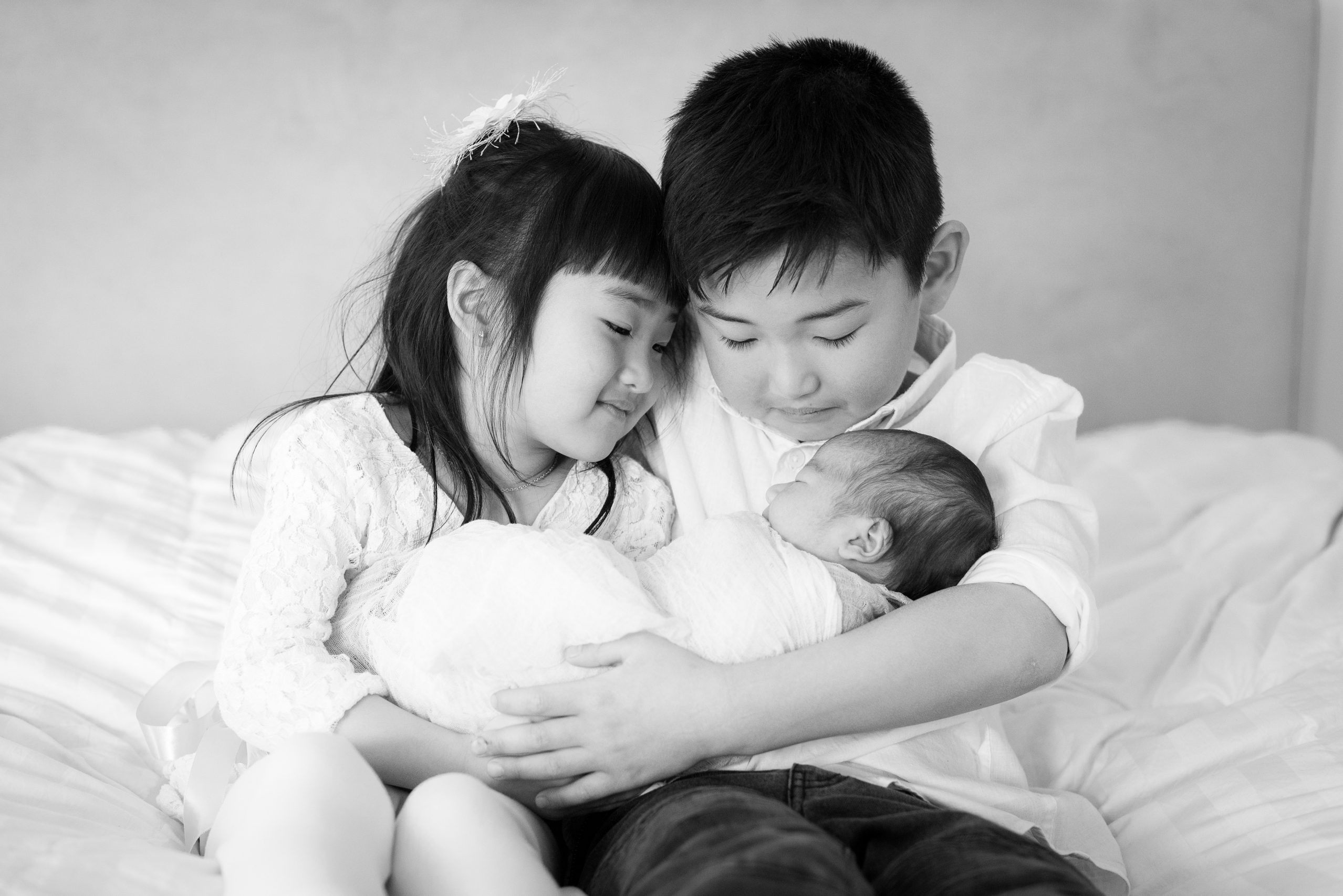 Preparing for newborn photo sessions in your home - older kids holding baby