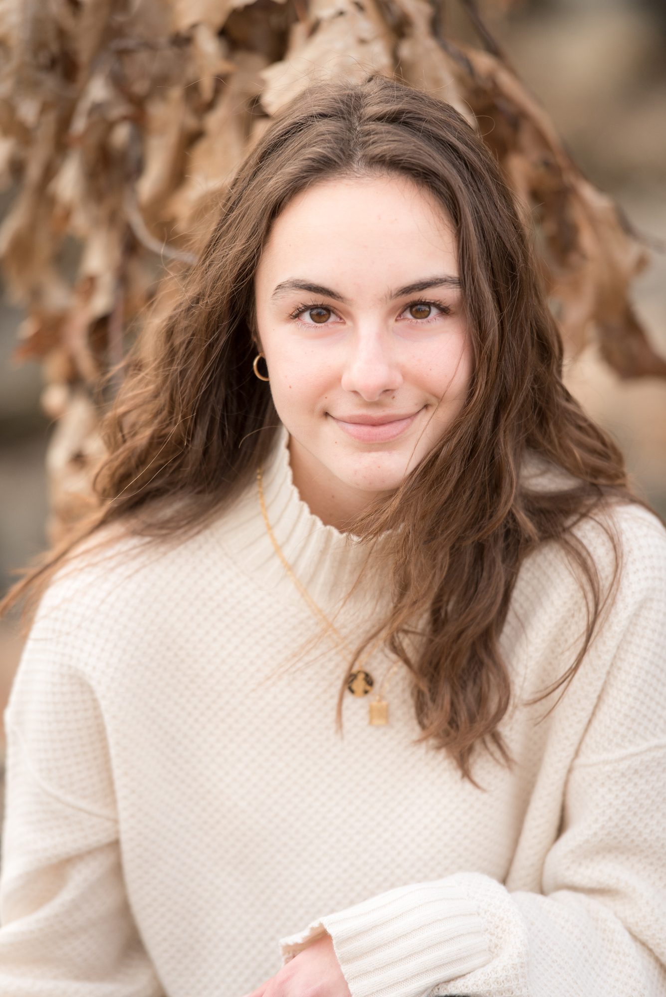 Head shot of a senior in a white sweater