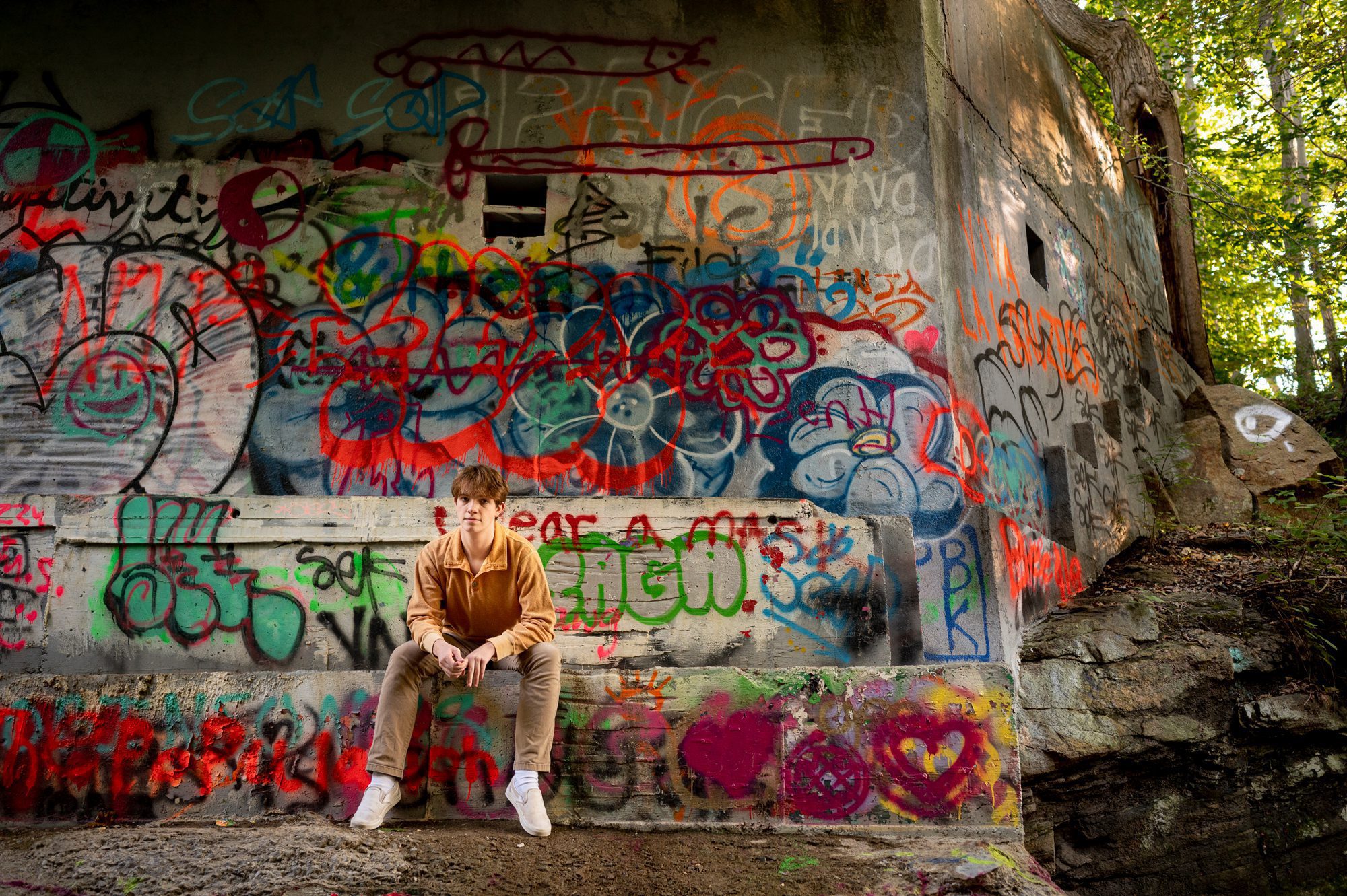 Teenager posing with graffiti