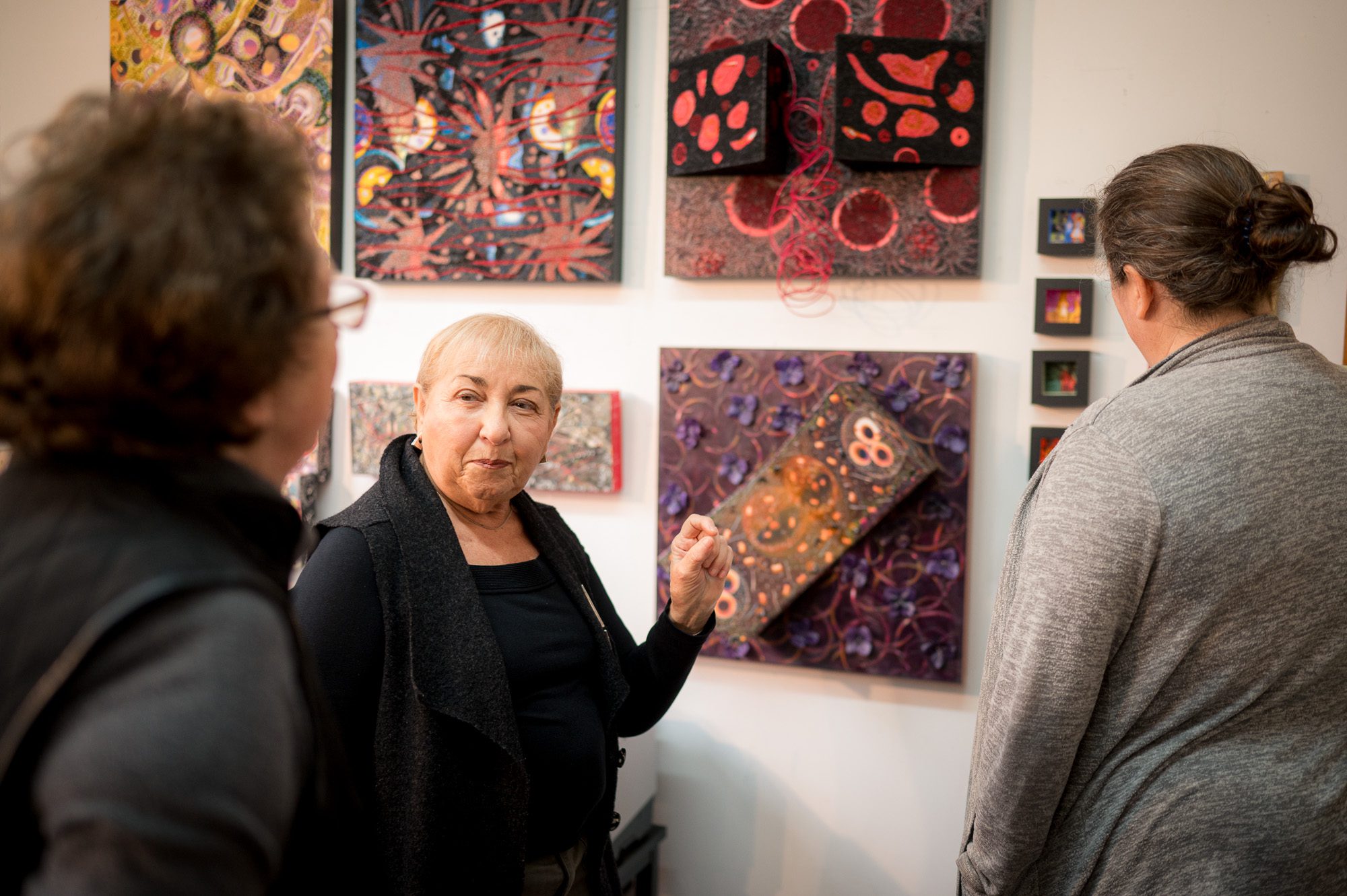 Artist showing her work to visitors