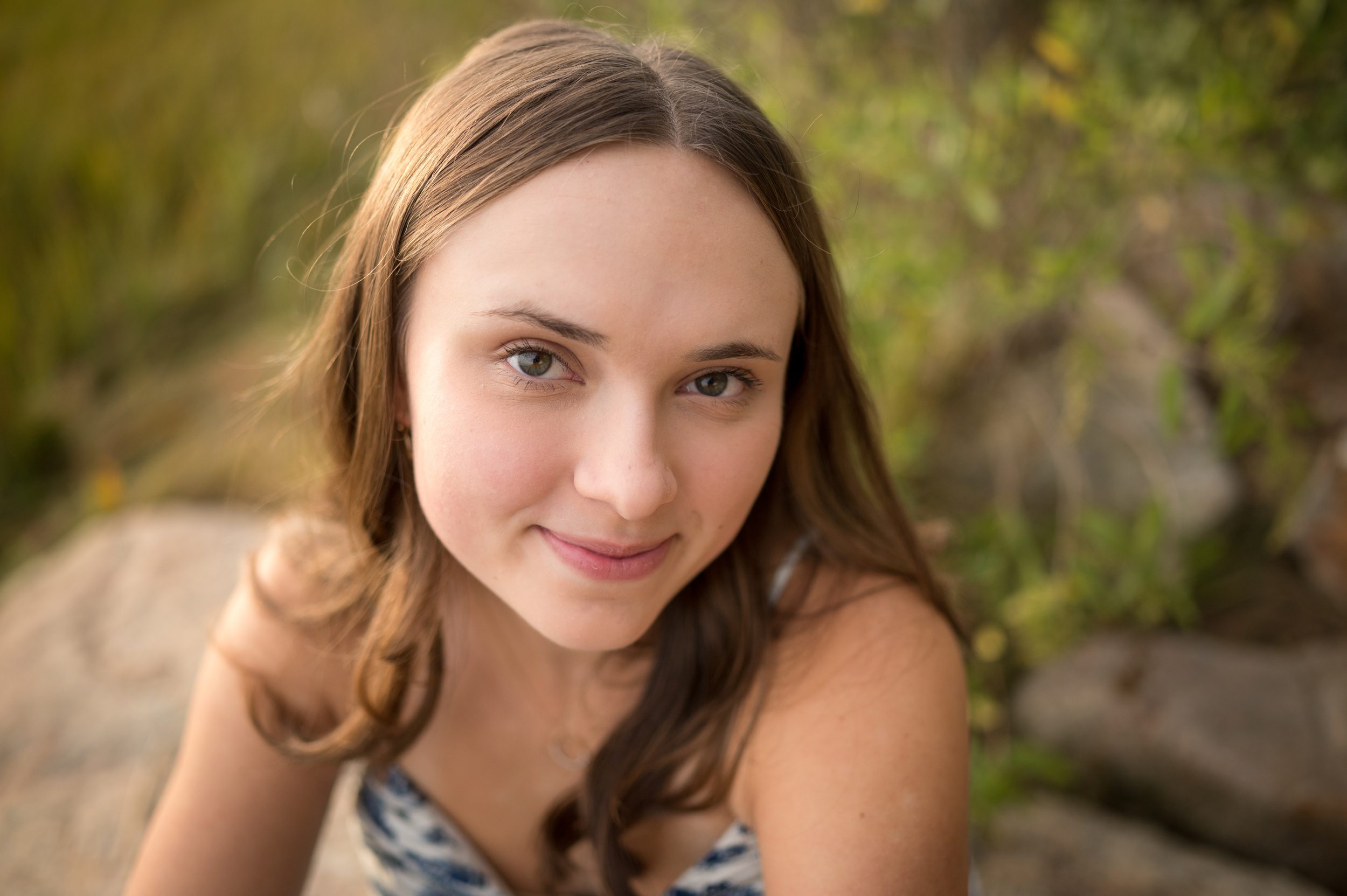 A close up of a high school senior sitting on a rock after attending a college fair in connecticut